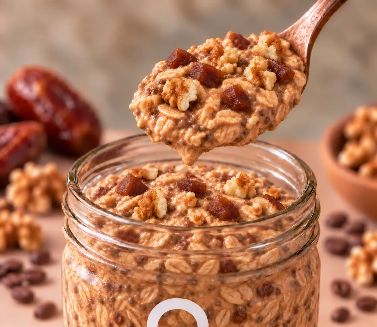 Spoonful of ero Coffee, Walnuts & Dates overnight oats being lifted from a glass jar—rich, energizing, high-protein breakfast.
