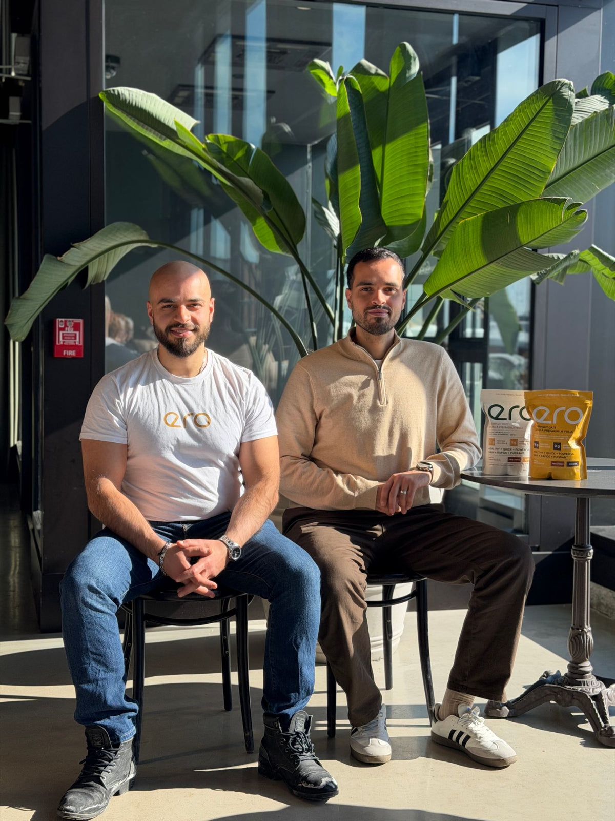 Moe and Ali, the brothers who founded ero, sitting by a window in Montréal with ero overnight oats